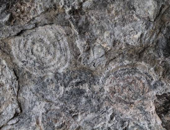 Mawanga Rock Art This site has an art on a panel covering about eight square metres, consisting of sets of concentric circles, mainly in alternating white and black with visible...