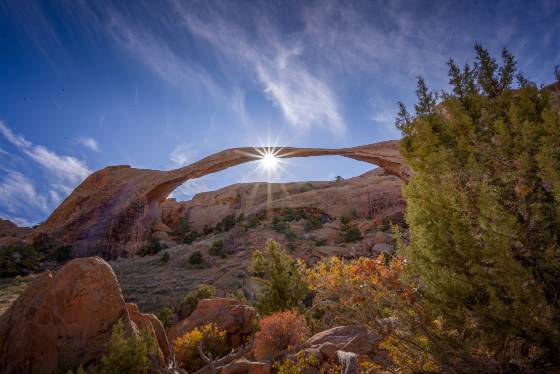 Landscape Arch Sunburst Sun setting over Landscape Arch in Arches NP