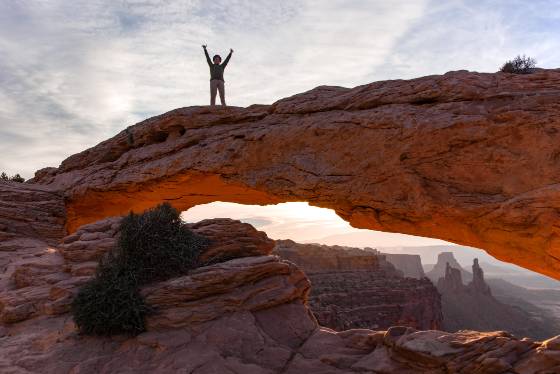 Elaine on Mesa Arch Person illegally on top of Mesa Arch in Canyonlands National Park.