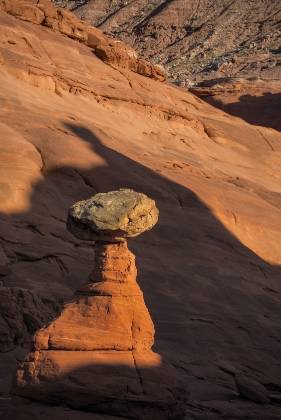 Hoodoo in Shadow Hoodoos of Dakota Caprock over Entrada Sandstone in Pedstal Alley near the Burr Trail in Utah.