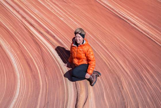 Elaine at The Wave Person seen against a sandstone pattern at The Wave in Coyote Buttes North, Arizona