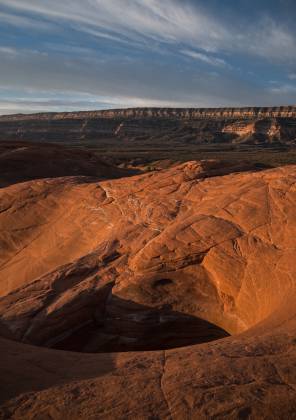 Slickrock Pothole with the Straight Cliffs in the background