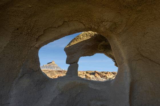 Two Hole Arch 2 Arches framing Factory Butte near Hanksville, Utah