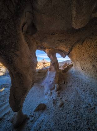 Three Hole Arch 2 Arches framing Factory Butte near Hanksville, Utah