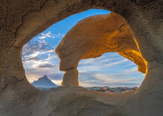 Two Hole Arch 2 Arches framing Factory Butte near Hanksville, Utah