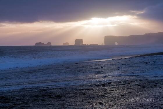 God rays over Reynisfjara Black Sand Beach God rays over Reynisfjara Black Sand Beach near Vik, Iceland.