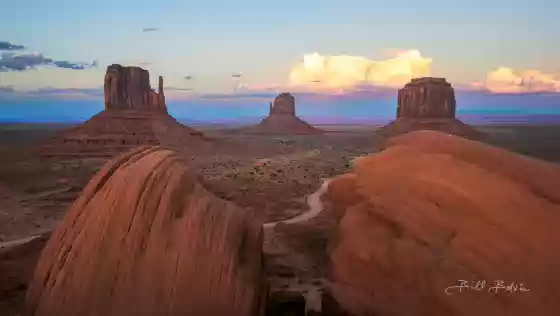 Sunset st The Mittens The MIttens and Merrick Butte seen from the Monument Valley Parking lot after sunset.