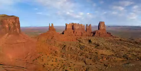 Stagecoach Butte at Sunset Aerial of Monument Valley showing from left to right Brigham Young's Tomb, King on his Throne, and Stagecoach Butte. Image taken at sunset.