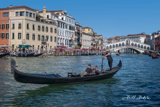 Gondolier 2 Gondolier on the Grand Canal in Venice, Italy. Rialto Bridge in the background.
