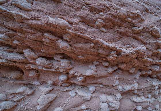 Embedded Stones Embedded stone in Owl Canyon, a wide slot canyon downstream of Mountain sheep canyon, in the Navajo Nation near Page, Arizona.