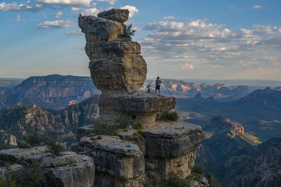 In Deep Thought Climber at Jenga Rock, aka Edge of the World Scenic Rock, overlooking Sedona, Arizona at sunset.