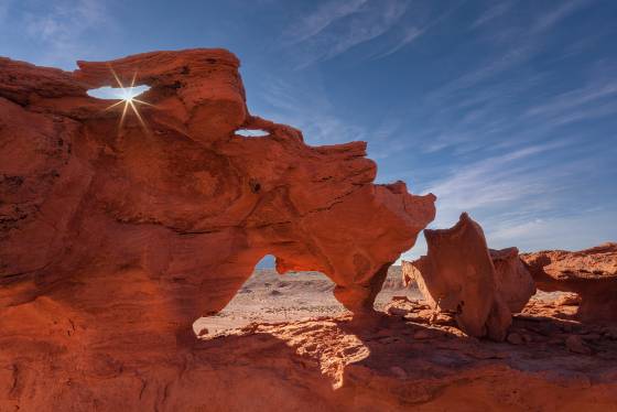 Sunburst and Arch Sunstar in arch in Little Finland, Nevada