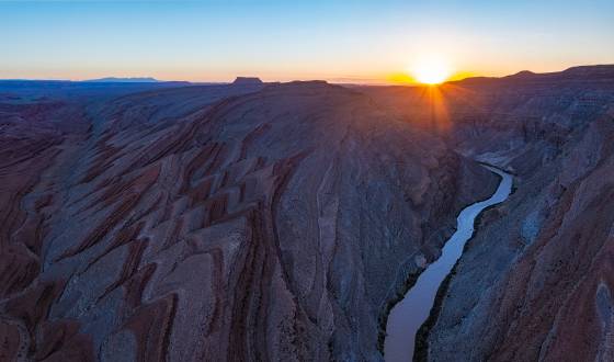 Sunrise over Rapele Ridge Raplee Ridge and the San Juan River seen at sunrise. Sugarloaf butte seen in the distance in the center of the image.