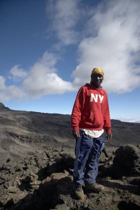 New York Sherpa wearing a New York sweatchirt on the way to the summit of Mount Kilimanjaro.