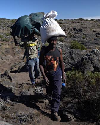Use your head Sherpas (porters) carring supplies on the Shira Plateau trail.