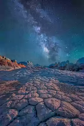 Pointing the Way The Milky Way rising over polygonal cracks at The White Pocket in Vermilion Cliffs NM
